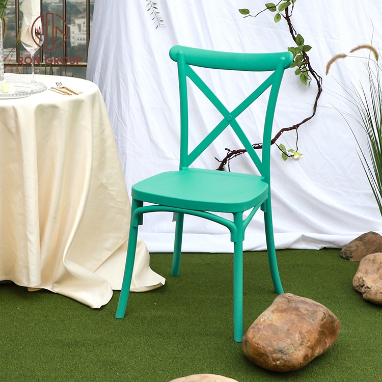 Hot sale stackable wholesale party event outdoor comfortable PP plastic green party dining wedding X cross back chairs